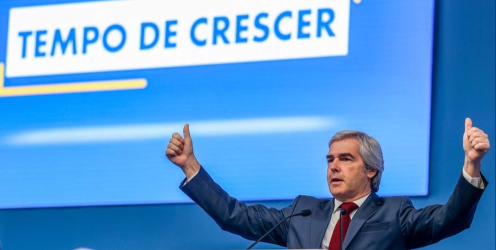 Nuno Melo ao púlpito com os braços erguidos e polegares para cima, em frente a um ecrã com o slogan 'Tempo de Crescer', durante o congresso do CDS-PP onde foi reeleito presidente.